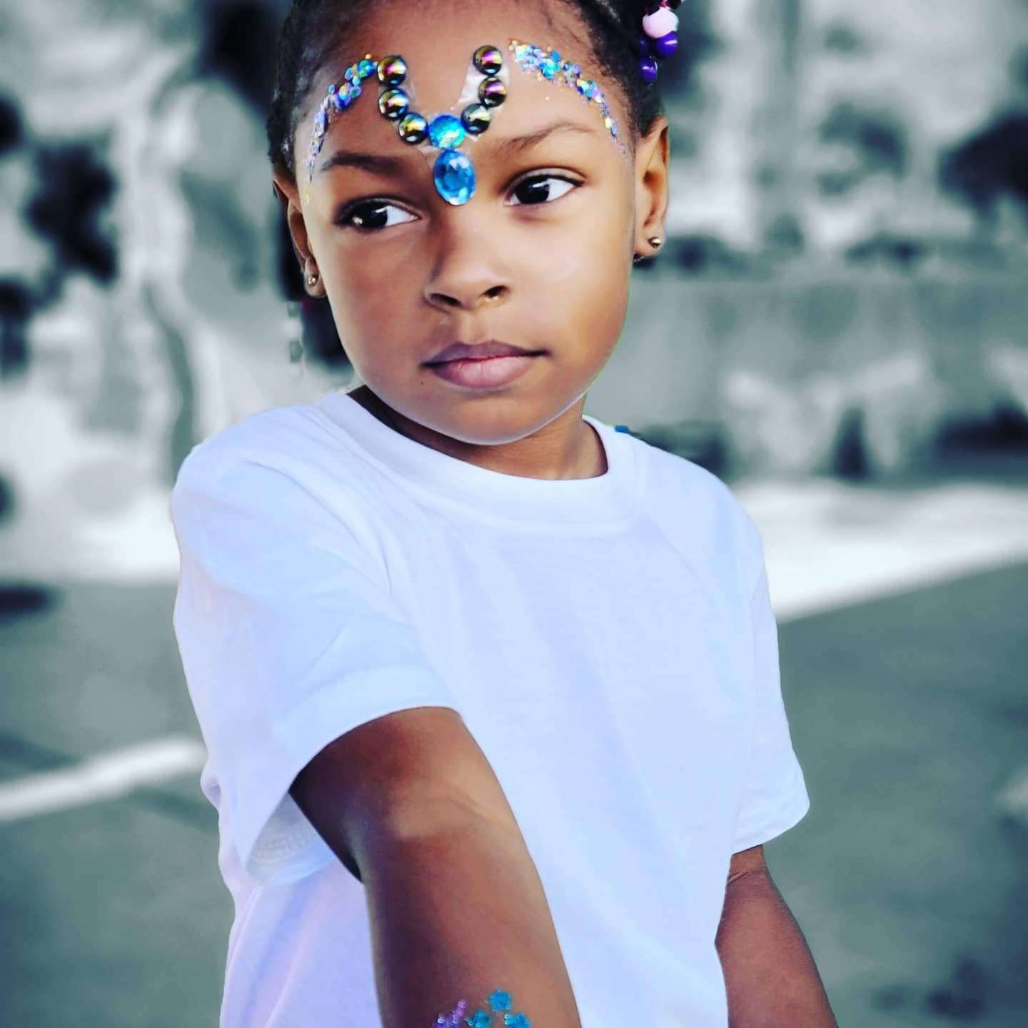 Gems and glitter on face
